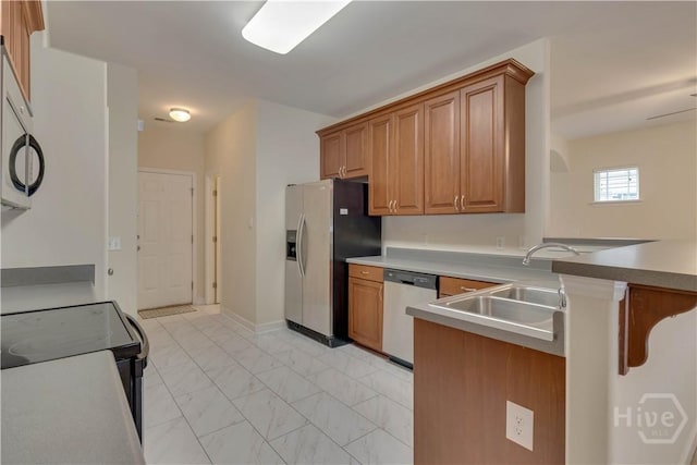 650 Summer Hill Way, Richmond Hill, GA 31324 - kitchen featuring light marble finish flooring, a peninsula, appliances with stainless steel finishes, and brown cabinetry