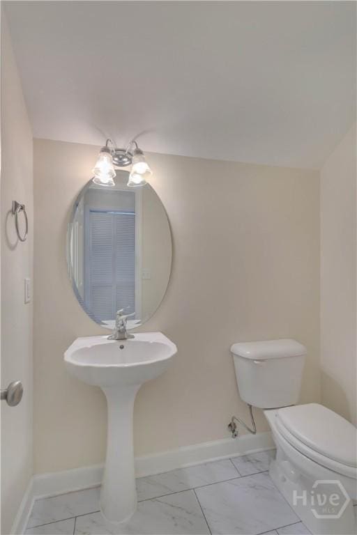 650 Summer Hill Way, Richmond Hill, GA 31324 - bathroom featuring marble look tiles and toilet