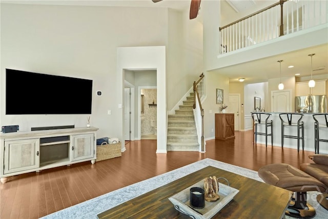 121 Belle Gate Dr, Pooler, GA 31322 - living room with stairs, wood finished floors, a ceiling fan, and a high ceiling