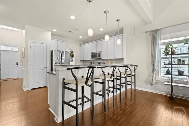 121 Belle Gate Dr, Pooler, GA 31322 - kitchen with dark wood-style flooring, a kitchen breakfast bar, white cabinets, and recessed lighting