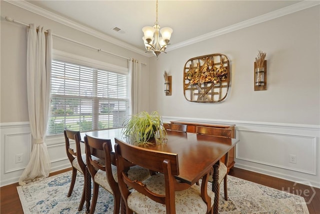 121 Belle Gate Dr, Pooler, GA 31322 - dining space with a chandelier, dark wood-type flooring, crown molding, and a wainscoted wall