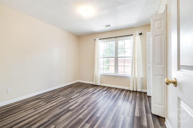 310 Tibet Ave Unit 52, Savannah, GA 31406 - unfurnished room featuring dark wood-style floors and a textured ceiling