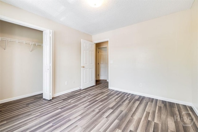310 Tibet Ave Unit 52, Savannah, GA 31406 - unfurnished bedroom featuring wood finished floors, a closet, and a textured ceiling