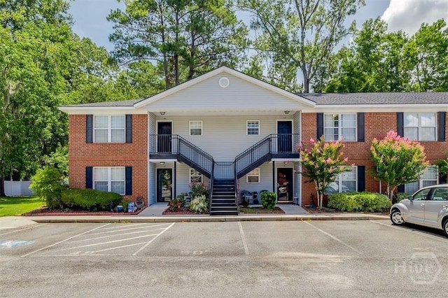 310 Tibet Ave Unit 52, Savannah, GA 31406 - view of front facade featuring stairs, uncovered parking, and brick siding