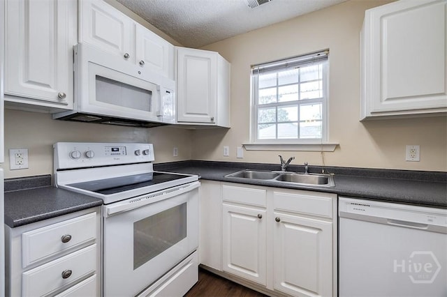 310 Tibet Ave Unit 52, Savannah, GA 31406 - kitchen featuring white appliances, dark countertops, white cabinets, and a textured ceiling