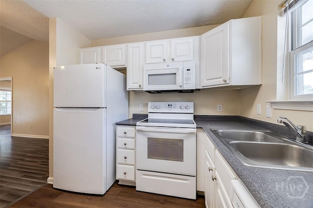 310 Tibet Ave Unit 52, Savannah, GA 31406 - kitchen with white appliances, white cabinetry, dark wood-style flooring, healthy amount of natural light, and a textured ceiling