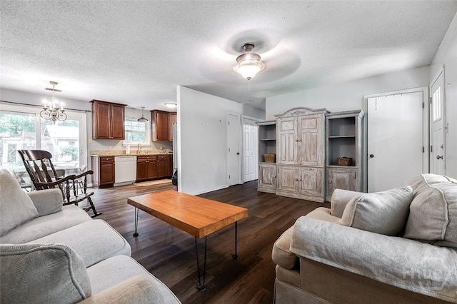 206 Pinecrest Pl, Pooler, GA 31322 - living area featuring plenty of natural light, dark wood-style flooring, a textured ceiling, a chandelier, and ceiling fan
