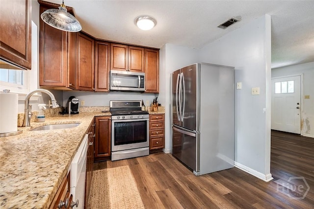 206 Pinecrest Pl, Pooler, GA 31322 - kitchen with appliances with stainless steel finishes, dark wood-style flooring, light stone counters, and brown cabinetry