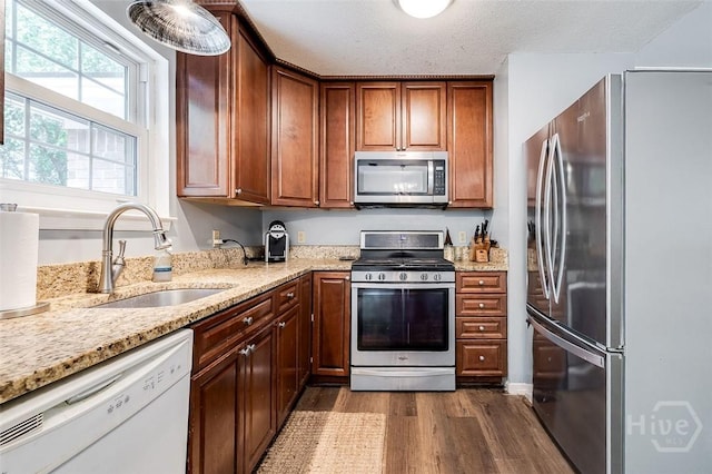 206 Pinecrest Pl, Pooler, GA 31322 - kitchen featuring stainless steel appliances, dark wood-style flooring, and light stone countertops