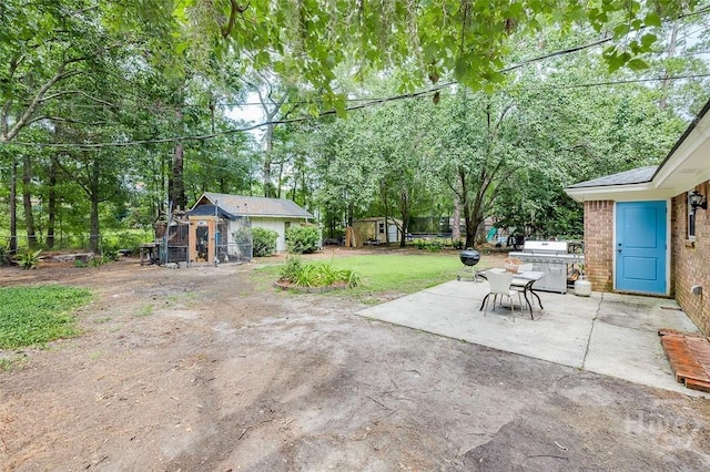 206 Pinecrest Pl, Pooler, GA 31322 - view of grassy yard with a patio, an outbuilding, and view of wooded area