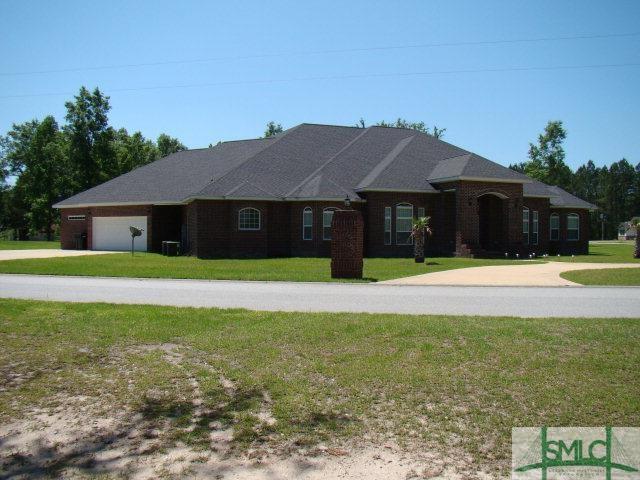 ranch-style home with a front lawn and a garage