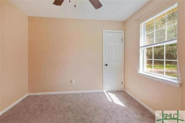 spare room featuring ceiling fan and light colored carpet