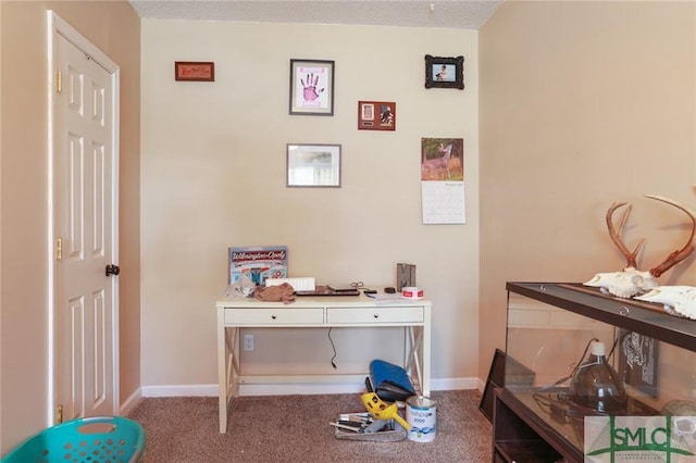 playroom featuring a textured ceiling and dark colored carpet