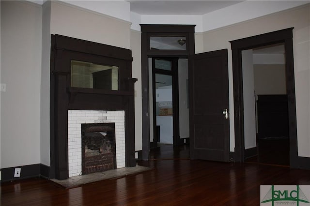 unfurnished living room featuring dark hardwood / wood-style flooring and a fireplace