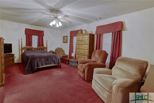 carpeted bedroom with a textured ceiling and ceiling fan