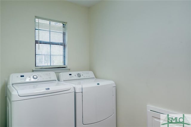 clothes washing area featuring separate washer and dryer