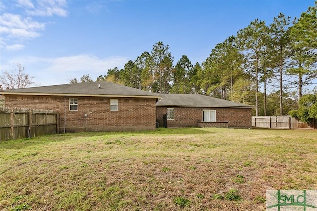 rear view of house with a lawn