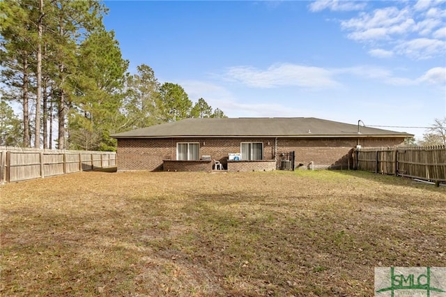 rear view of house featuring a lawn