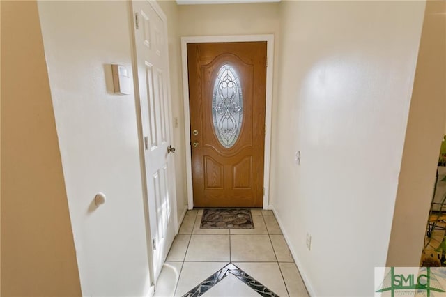 doorway to outside with light tile floors