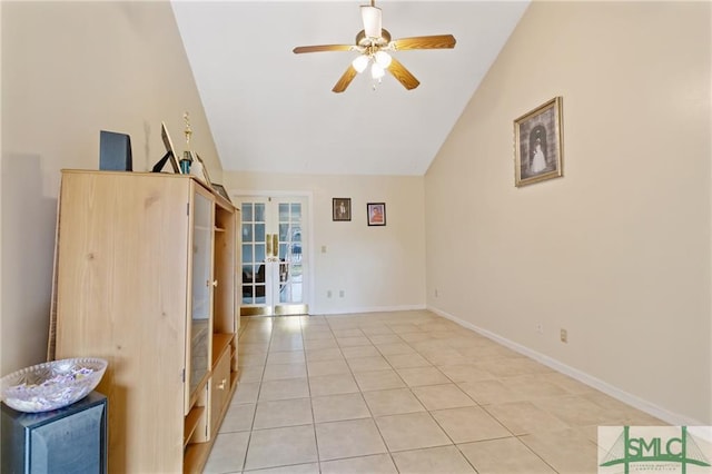 unfurnished room with ceiling fan, french doors, vaulted ceiling, and light tile flooring