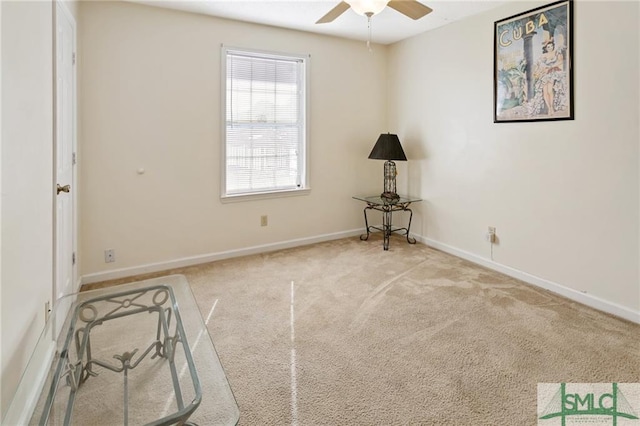 empty room featuring ceiling fan and light colored carpet