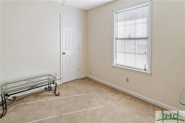 unfurnished room with light colored carpet