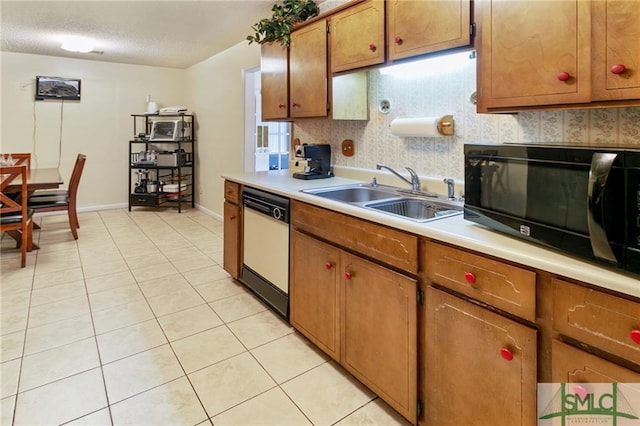 kitchen featuring sink, light tile floors, and white dishwasher