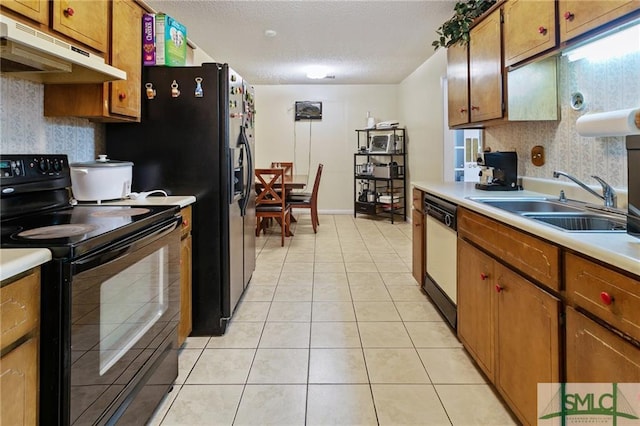 kitchen with light tile floors, black range with electric stovetop, white dishwasher, and sink