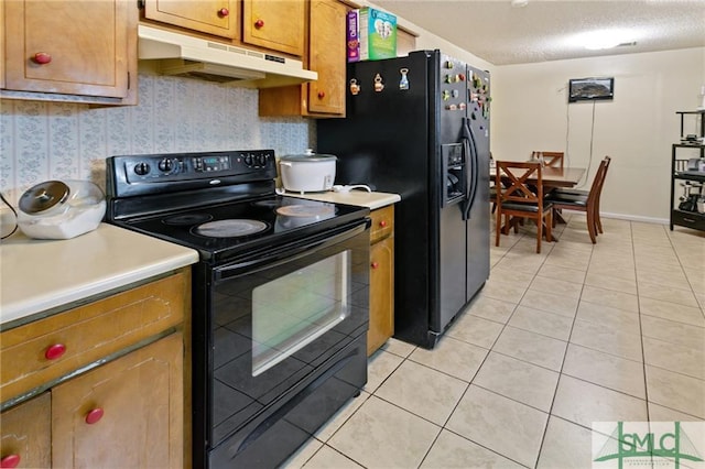 kitchen with a textured ceiling, black appliances, and light tile floors