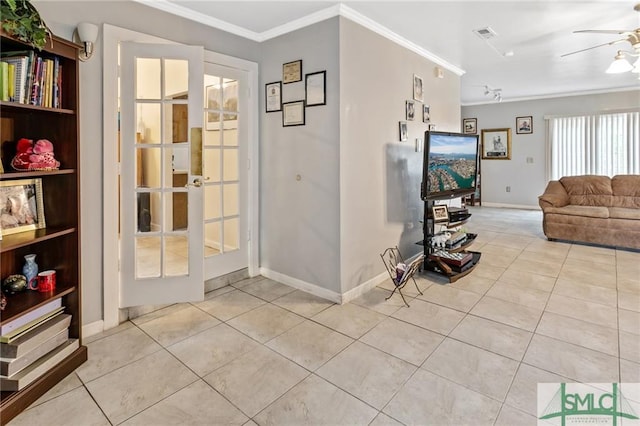 doorway with french doors, crown molding, ceiling fan, and light tile flooring