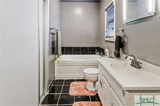 bathroom featuring toilet, tile flooring, a bathing tub, and vanity