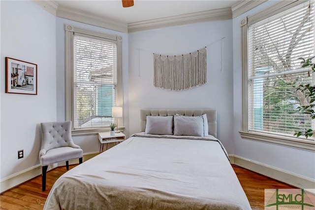 bedroom with ceiling fan, dark hardwood / wood-style floors, and crown molding