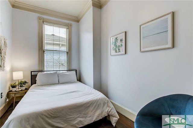 bedroom with crown molding and dark hardwood / wood-style flooring