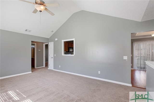 unfurnished room with light carpet, ceiling fan, and high vaulted ceiling