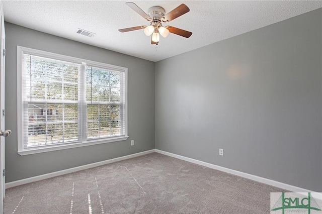 unfurnished room featuring light carpet, a healthy amount of sunlight, and ceiling fan