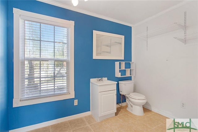 bathroom featuring tile floors, ornamental molding, toilet, and vanity