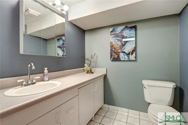 bathroom featuring tile flooring, toilet, and vanity