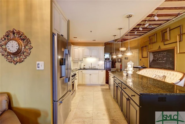 kitchen featuring light tile floors, a kitchen island, dark stone countertops, stainless steel refrigerator with ice dispenser, and white cabinetry