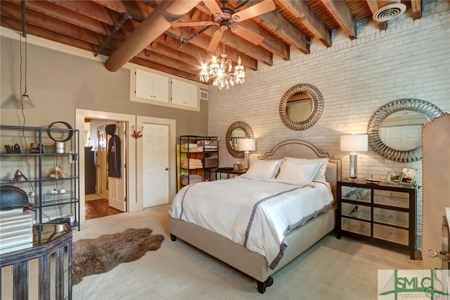 carpeted bedroom with a high ceiling, ceiling fan with notable chandelier, beamed ceiling, brick wall, and wooden ceiling