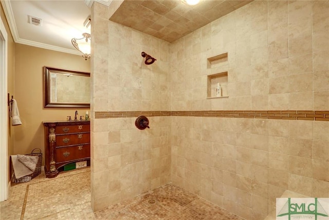 bathroom with crown molding and a tile shower