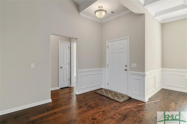 foyer entrance featuring beamed ceiling, crown molding, and dark hardwood / wood-style flooring