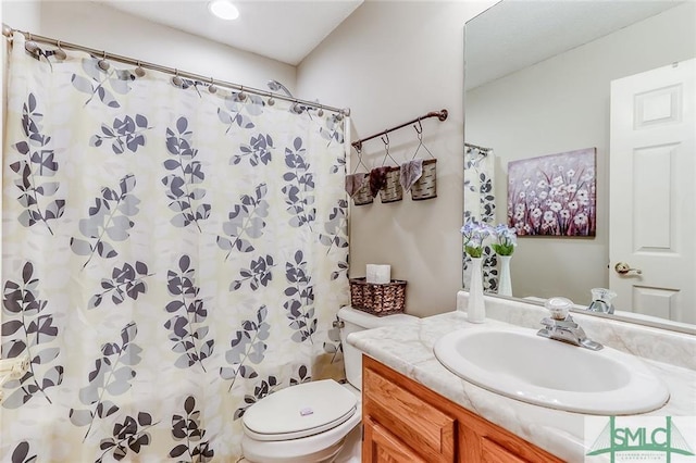 bathroom featuring toilet and vanity