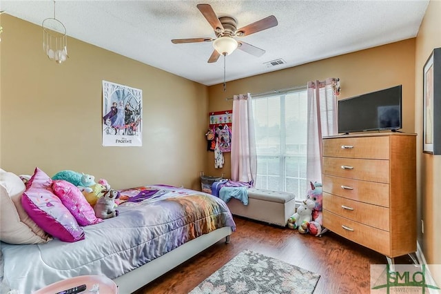 bedroom featuring dark hardwood / wood-style flooring and ceiling fan