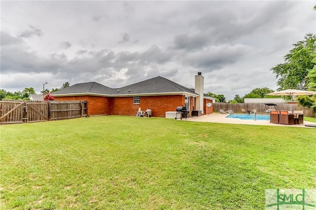 view of yard with a fenced in pool and a patio area