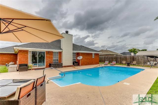 view of swimming pool featuring a patio area