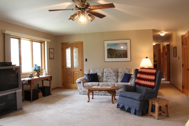 carpeted living room with ceiling fan