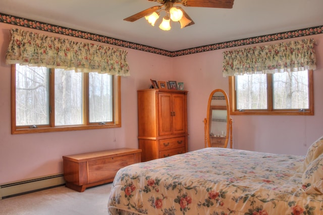 bedroom with ceiling fan, a baseboard radiator, and light carpet