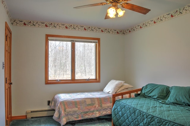 bedroom with ceiling fan, carpet flooring, a baseboard heating unit, and multiple windows