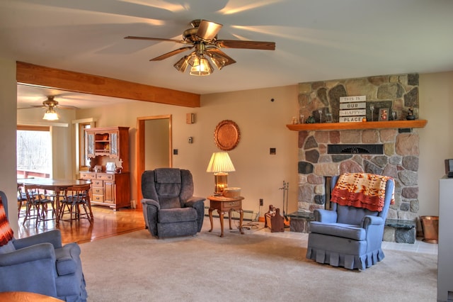 living room featuring ceiling fan, a baseboard radiator, light carpet, and a fireplace