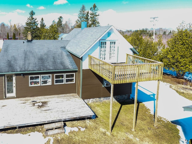 rear view of property with a deck and a lawn